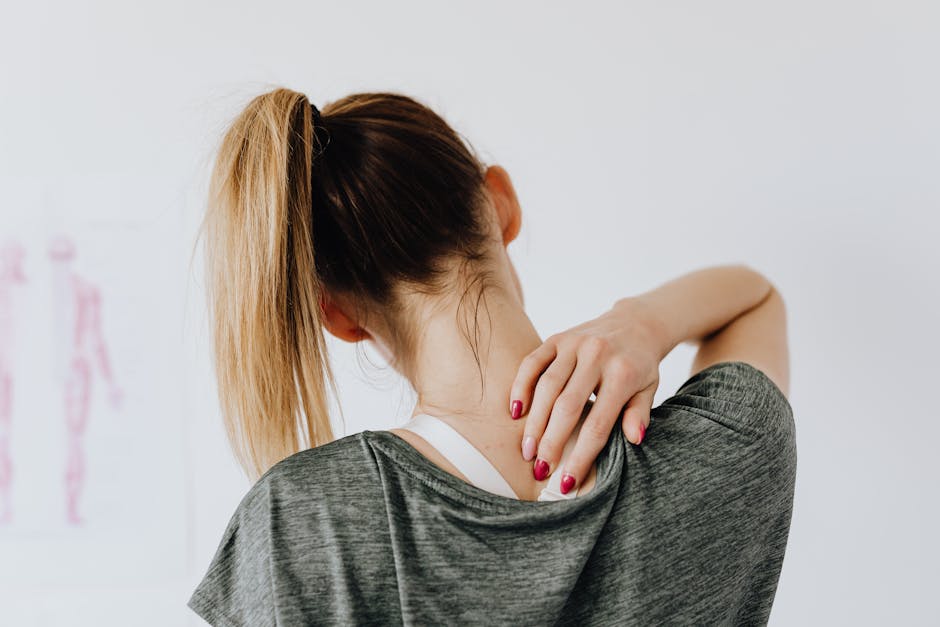 Person doing neck and shoulder stretches at desk